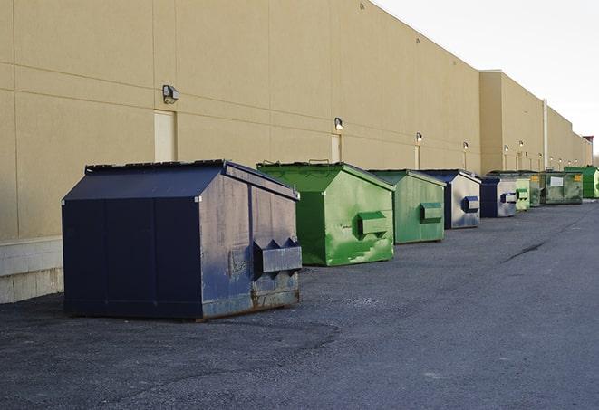 a row of yellow and blue dumpsters at a construction site in East Greenwich, RI